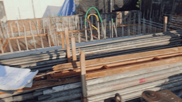 Construction site with metal pipes and plans
