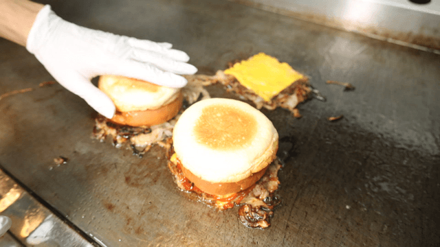 Burger cooking on hot grill