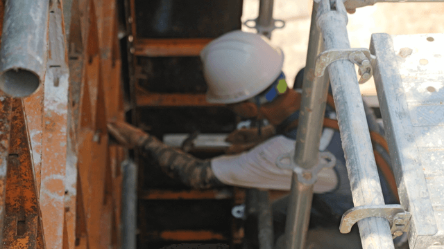 Construction workers assembling scaffolding