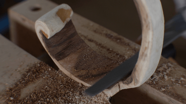 Woodcraft artisan shaping wood with precision file