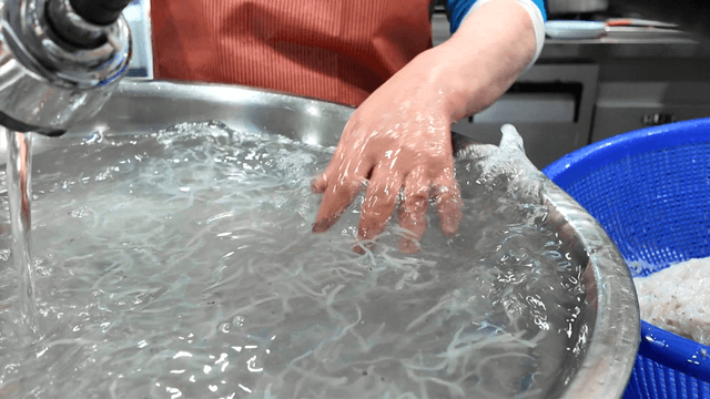 Ice fish lifted with chopsticks from kitchen sink