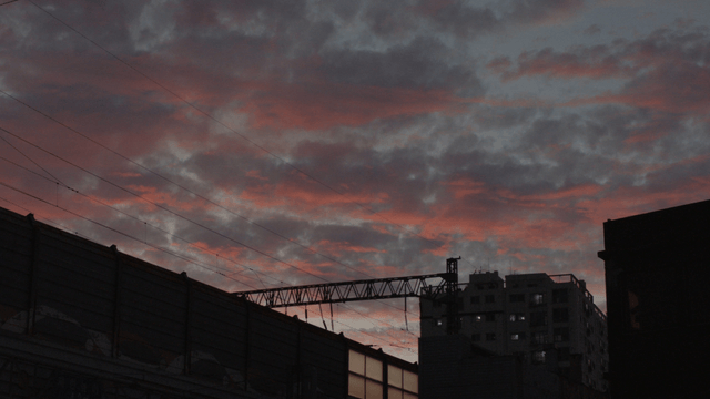 Train and residential area under a colorful sunset