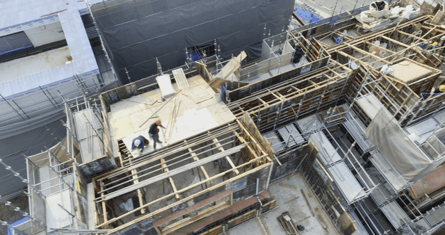 Construction site with workers and scaffolding