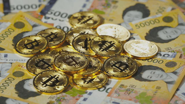 Bitcoin coins on Korean won bills