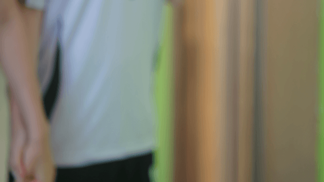 Two people holding hands in a hallway