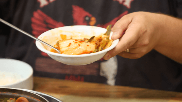 Kimchi placed on a bowl of budaejjigae
