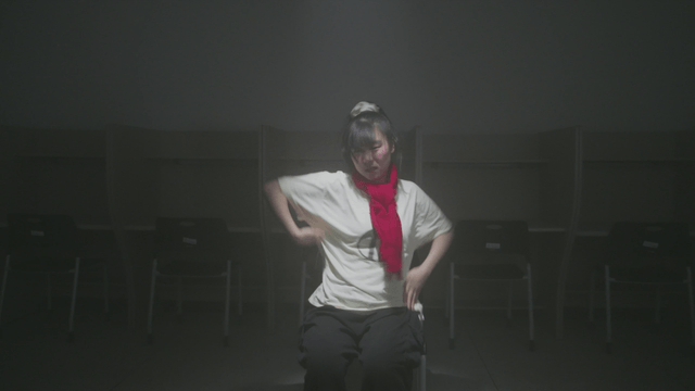 Girl dancing in a dark reading room