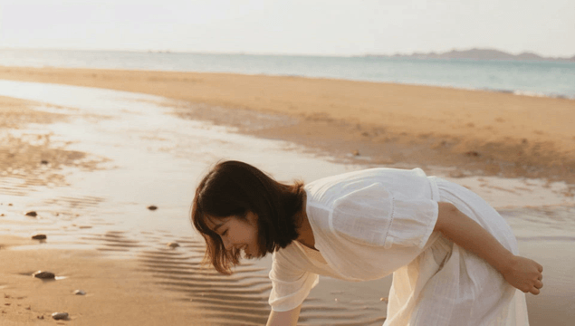 Woman collecting seashells on sunny beach