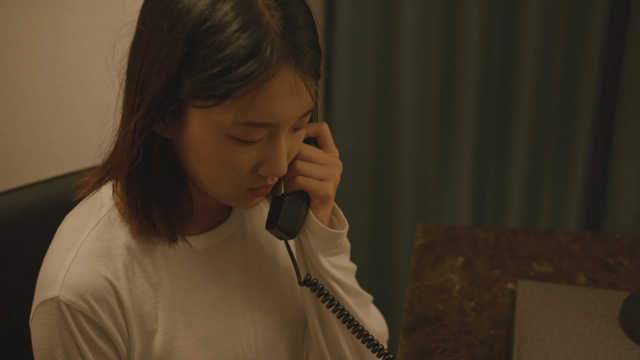 Profile of a woman talking on the phone