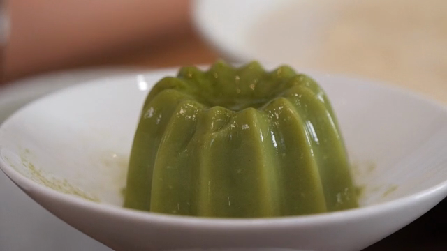 Green pudding in a white bowl