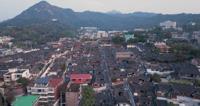 Traditional hanok village with distant mountain view