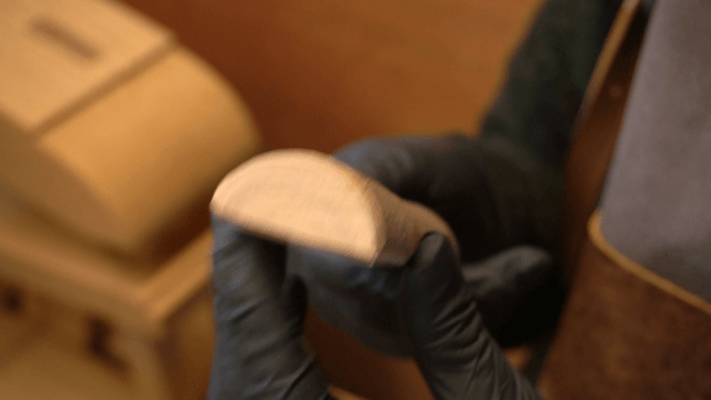 Artisan holding a wooden piece