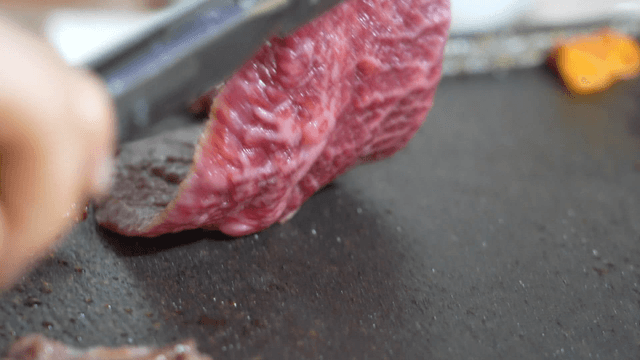 Fresh beef grilling on hot iron plate