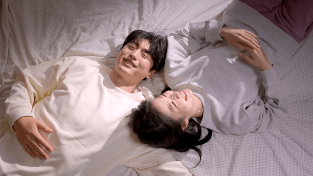 Couple lying on a bed in a cozy room