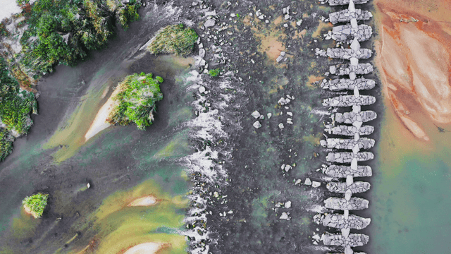 Aerial view of a stone bridge along the river