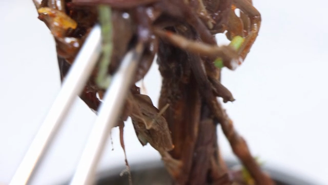 A chopstickful of bracken fern in sundae soup