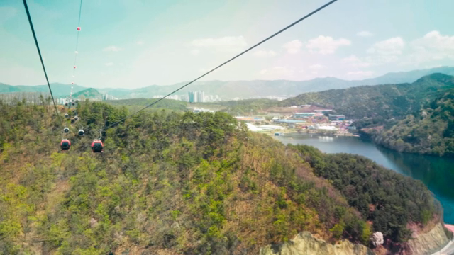 Cable cars over a scenic mountain landscape