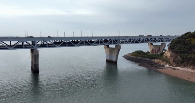 A large bridge spanning over calm water