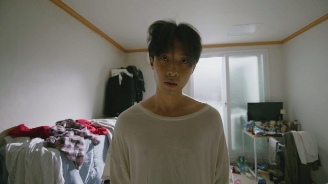 Young man in a messy room