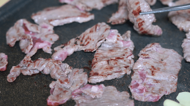 Beef grilling on hot iron plate