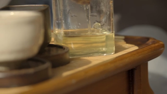 Pouring hot water into a tea strainer
