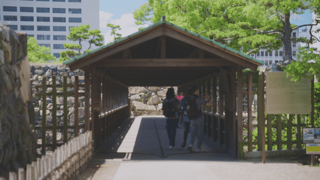 People walking through a wooden bridge
