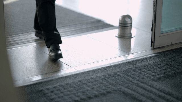 People walking through a glass door