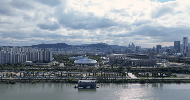 Urban landscape with stadium and river