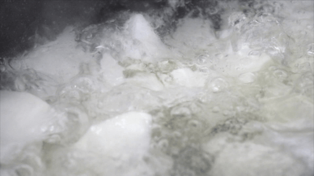 Boiling water with pieces of white radish