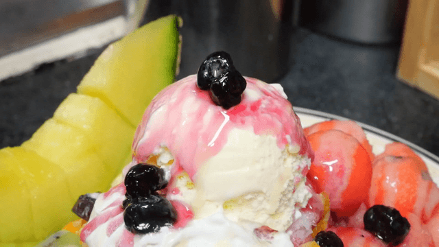 Blueberry syrup poured on fruit shaved ice
