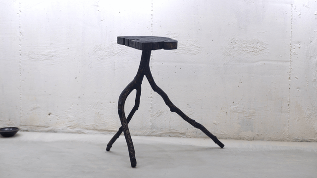 Unique wooden stool in a minimalist room