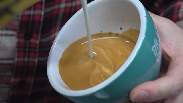 Latte art being created in a coffee cup