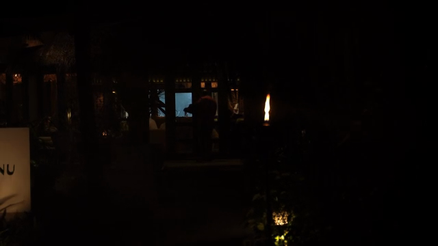 A dimly lit restaurant with people inside