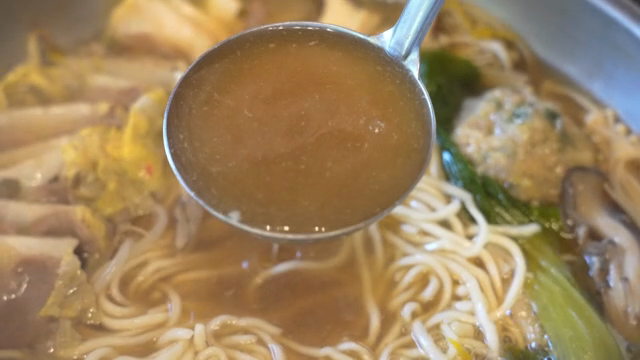 Broth from Korean hot pot with noodles and vegetables