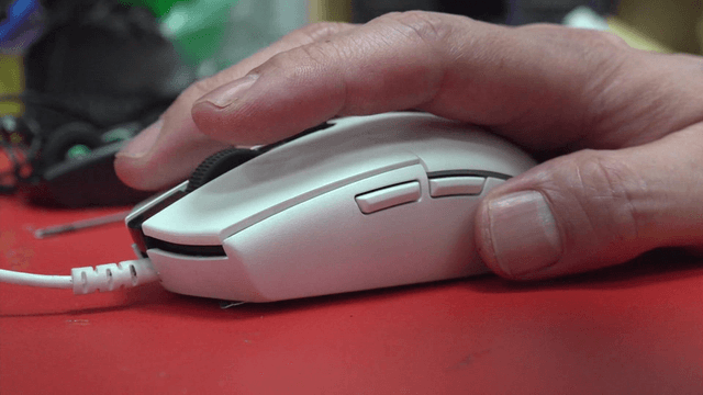 Hand using a computer mouse on a desk