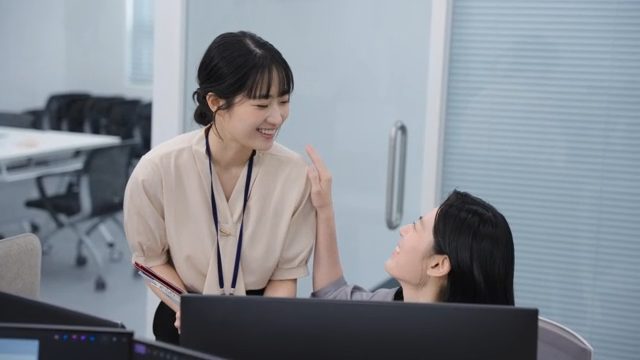 Two colleagues discussing work at a desk