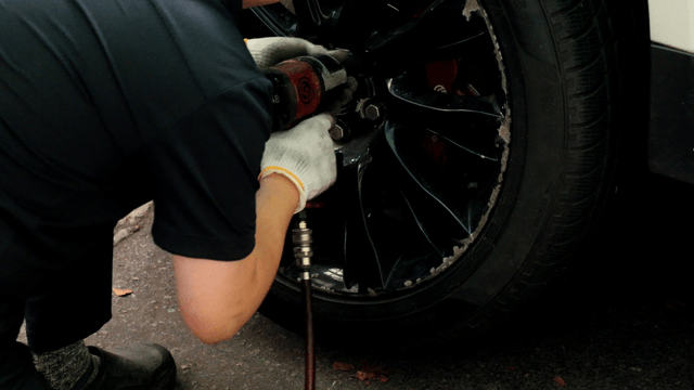 Mechanic working on a car tire
