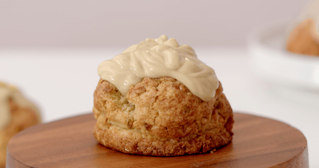 Cream poured over scone with nuts