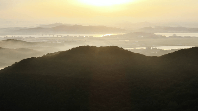 Sunrise over a misty mountain landscape
