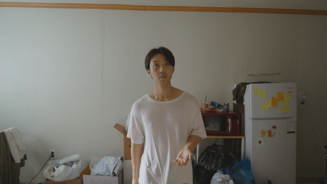 Man standing in a cluttered room