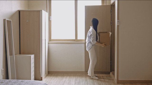 Woman organizing a room with a box