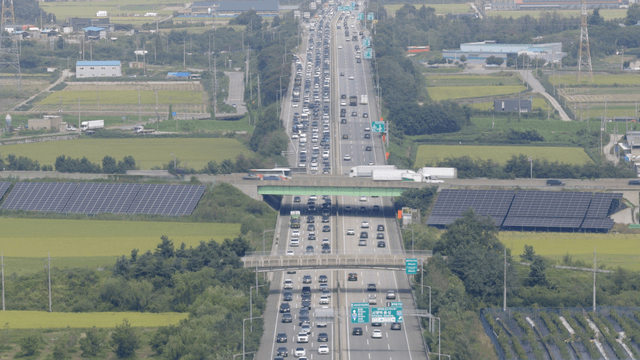 Highway traffic across rural fields