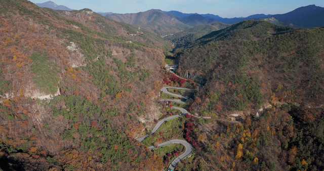Winding mountain road with autumn foliage