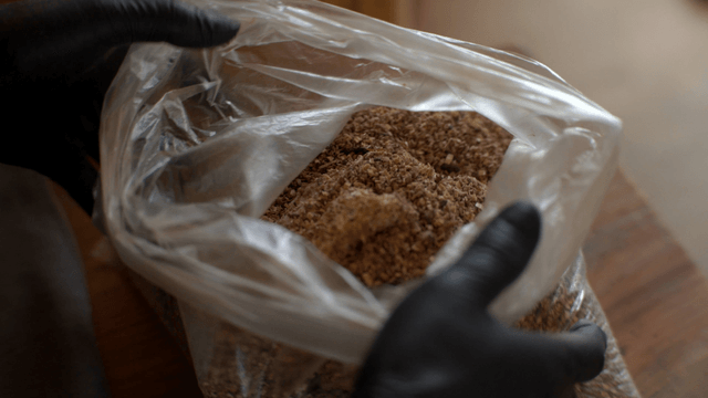 Woodcraft artisan mixing wood glue and sawdust