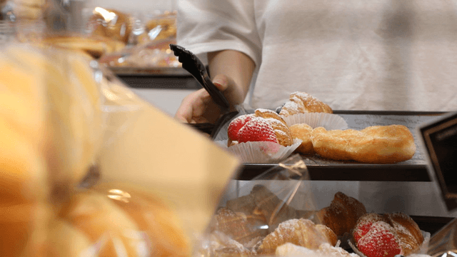 Selecting pastries in a bakery