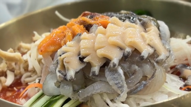 Preparing Cold Raw Fish Soup with fresh abalone on top