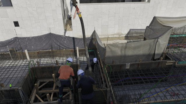 Construction workers pouring concrete