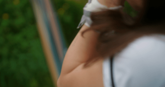 Schoolgirl quickly taking a pink pill outdoors