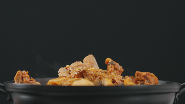 Pork backbone stew in steaming pot