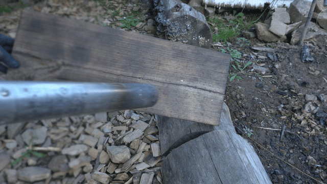 Artisan torching the surface of wood in workshop